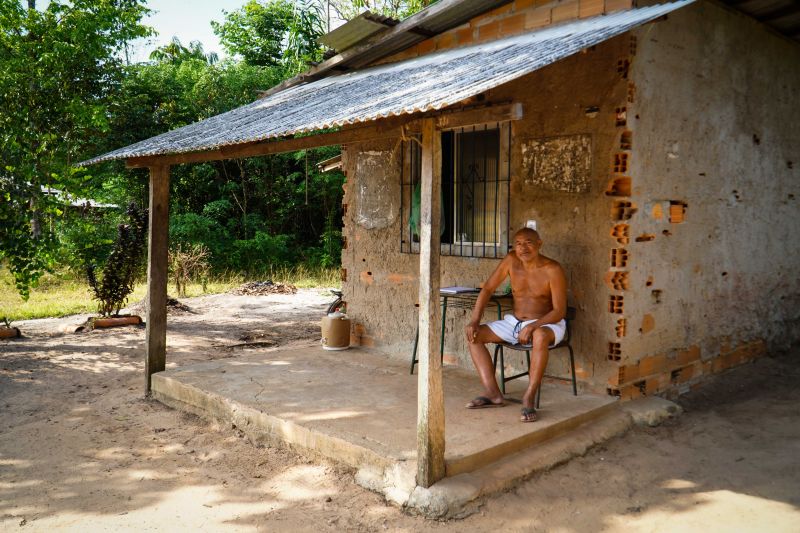 Senhor sentado na porta de casa
